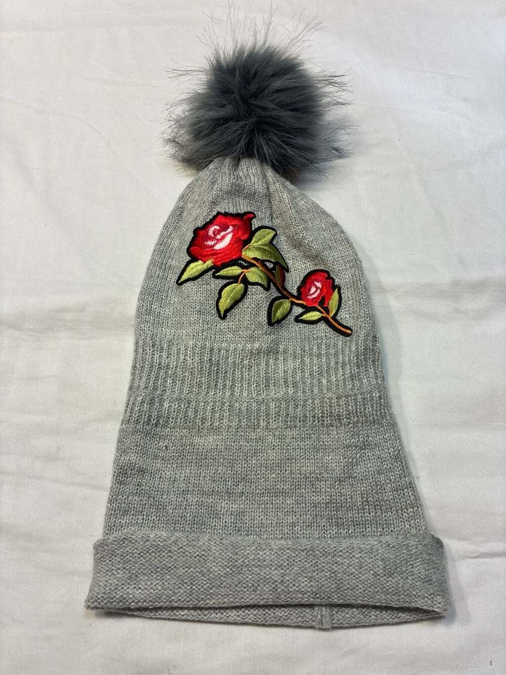 Tickled Pink Grey Knit Beanie with Embroidered Rose and Faux Fur Pom Pom